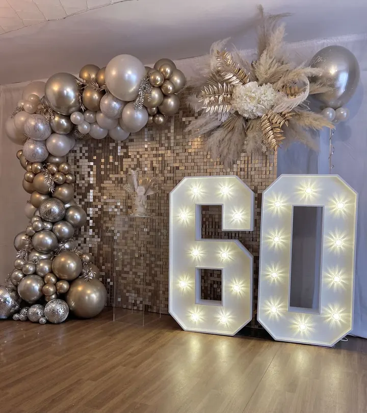 Chrome silver and gold balloon garland with a sequin wall and light-up 60 numbers