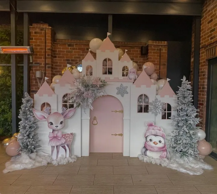 Pink and white castle backdrop with frosted trees and woodland animal cut-outs